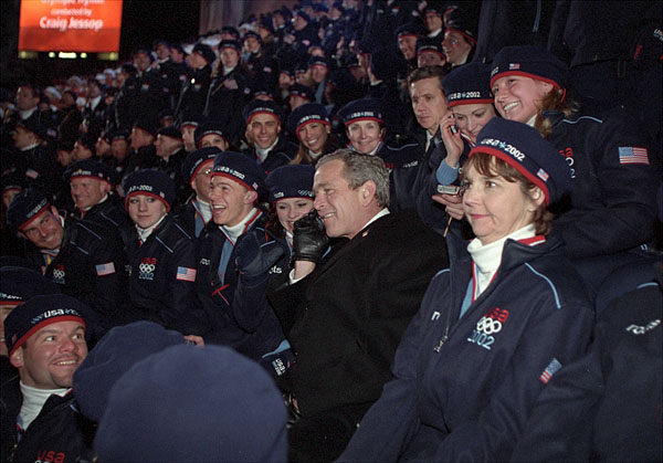 Taking a phone call from an athlete's family, President George W. Bush sits with America's Olympic athletes during the opening ceremonies for the 2002 Winter Olympic Games in Salt Lake City, Utah, Feb. 8. White House photo by Paul Morse.