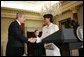 President Bush shakes hands with Dr. Condoleezza Rice after introducing her those in attendence for her ceremonial swearing-in at the U.S. Department of State Friday, Jan. 28, 2005. White House photo by Eric Draper