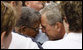 President George W.B ush embraces a family member during the Pentagon Memorial dedication ceremony Thursday, Sept. 11, 2008 at the Pentagon in Arlington, Va., where 184 memorial benches were unveiled honoring all innocent life lost when American Airlines Flight 77 crashed into the Pentagon on Sept. 11, 2001. White House photo by Eric Draper