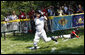 Five-year-old Alex Thaler of the Eastern U.S. All-Stars makes a valiant effort as Jackson McGough of the Central U.S. All-Stars crosses the plate Wednesday, July 16, 2008, during All-Star Tee Ball at the White House. Players from across the United States gathered for the first time on the White House lawn to play the doubleheader that matched the Southern U.S. against the Western U.S. in the second game. White House photo by Eric Draper