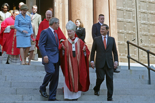 President George Bush walks out of St. Matthew's Cathedral with Cardinal Theodore McCarrick and Supreme Court Chief Justice John Roberts after attending the 52nd Annual Red Mass in Washington, DC, Sunday, October 2, 2005. The Red Mass, a historical tradition within the Catholic Church, is held on the Sunday before the opening session of the Supreme Court. White House photo by Shealah Craighead