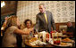 President George W. Bush shakes the hand of a patron at Stamey's barbeque in Greensboro, N.C., during a lunch with community leaders Wednesday, Oct. 18, 2006. White House photo by Paul Morse