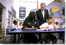 President George W. Bush talks with students at the South End Community Center in Bridgeport, Conn., Tuesday, April, 9. Americorps volunteers come to the community center to mentor students. "We need to encourage programs to expand, to give people an outlet, a chance to participate," said the President during his remarks at the city's Klein Auditorium where he oulined how people could join the ranks of thousands who are already serving in one America's Freedom Corps groups. White House photo by Tina Hager.