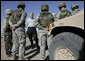 President George W. Bush stands amidst camouflaged troops Monday, April 9, 2007, during his tour of the U.S.-Mexico border in Yuma, Ariz. White House photo by Eric Draper