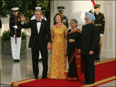 President George W. Bush and Laura Bush welcome India Prime Minister Dr. Manmohan Singh and Mrs. Gursharan Kaur, as they arrive for the official dinner at the White House, Monday, July 18, 2005. White House Photo by Krisanne Johnson