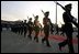 A Japanese honor guard marches out to greet the arrival of Vice President Cheney and Mrs. Cheney to Tokyo April 10, 2004. 