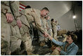 Mrs. Laura Bush greets U.S. and Coalition troops Wednesday, March 1, 2006, during a stopover at Bagram Air Base in Afghanistan, prior to the President and Mrs. Bush visiting India and Pakistan.