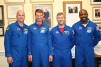 Space Shuttle Atlantis astronauts Alan Poindexter, Stanley Love, Steve Frick, and Leland Melvin, wearing blue flight suits