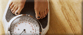 A picture of a woman standing on a bathroom scale