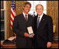 President George W. Bush stands with Dr. Mitch Besser after presenting him with the 2008 Presidential Citizens Medal Wednesday, Dec. 10, 2008, in the Oval Office of the White House. White House photo by Chris Greenberg