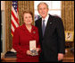 President George W. Bush stands with Dr. Anne M. Radice after presenting her with the 2008 Presidential Citizens Medal Wednesday, Dec. 10, 2008, in the Oval Office of the White House. White House photo by Chris Greenberg