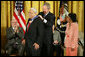 President George W. Bush awards the Presidential Medal of Freedom to civil rights activist Benjamin Hooks as his wife Frances Hooks stands by during a ceremony Monday, Nov. 5, 2007, in the East Room. "The nation best remembers Benjamin Hooks as the leader of the NAACP. For 15 years, Dr. Hooks was a calm yet forceful voice for fairness, opportunity, and personal responsibility. He never tired or faltered in demanding that our nation live up to its founding ideals of liberty and equality," said the President. White House photo by Eric Draper