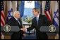 President George W. Bush and Israeli Prime Minister Ariel Sharon during a press conference in the Cross Hall of the White House on April 14, 2004. White House photo by Paul Morse.