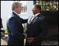 President George W. Bush is greeted by President Jakaya Kikwete of Tanzania, upon his arrival Sunday, Feb. 17, 2008, at the State House in Dar es Salaam. White House photo by Eric Draper