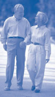 Image of an elderly couple are holding hands and walking.