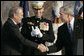 President George W. Bush and Secretary of Defense Donald Rumsfeld shake hands following President Bush's remarks honoring outgoing Secretary Rumsfeld during an Armed Forces Full Honor Review at the Pentagon Friday, Dec. 15, 2006, as Joint Chiefs of Staff Chairman General Peter Pace applauds.  White House photo by Paul Morse