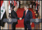 President George W. Bush shakes hands with Iraqi Prime Minister Nouri al-Maliki at the conclusion of their joint press availability in the East Room of the White House Tuesday, July 25, 2006. White House photo by Kimberlee Hewitt