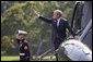 President George W. Bush waves as he prepares to depart the White House aboard Marine One from the South Lawn en route to Andrews AFB for his trip to Michigan, Friday, Sept. 8, 2006.  White House photo by Eric Draper