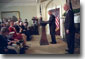 President George W. Bush and Jim Towey pause to smile at Mr. Towey's children during the Ceremony in which the President names him as the Director of the Faith-Based & Community Initiatives Director in the Roosevelt Room Feb. 1. "The purpose of this initiative recognizes the power of faith in helping heal some of our nation's wounds," said the President. "And today, I'm honored to name Jim Towey as its new head and new director. He has served a Republican senator and a Democratic governor. He understands there are things more important than political parties." White House photob by Eric Draper.