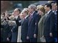 President George W. Bush and Laura Bush stand with Russian President Vladimir Putin and Lyudmila Putina, French President Jacque Chirac, far left, and Chinese President Hu Jintao, right, as many heads of state watch a parade in Moscow's Red Square commemorating the end of World War II Monday, May 9, 2005.  White House photo by Eric Draper