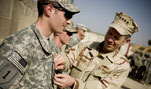 U.S. Navy Adm. Mike Mullen, chairman of the Joint Chiefs of Staff, promotes U.S. Army 1st Lt. Travis Lee to captain during a ceremony at Combat Outpost Banchee, Iraq, March 1, 2008.