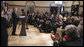 President George W. Bush and members of the audience acknowledge Thomas Boyd, at right in dark shirt, after the President mentioned him in remarks Wednesday, April 9, 2008, during the signing of H.R. 1593, the Second Chance Act of 2007. The Second Chance Act aims to reduce prison populations and corrections costs by reducing the recidivism rate by providing federal funding to develop programs dealing with job training, substance abuse, and family stability. In acknowledging Mr. Boyd, a 53-year-old graduate of the Jericho re-entry program in Baltimore, the President said, "I want to thank you for coming, Thomas. There's a lot of other Thomases out there that we're going to help with this bill."  White House photo by Eric Draper