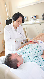 An acupuncturist works with a patient.