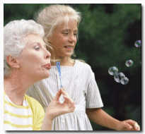 Woman Blowing Bubbles with Child