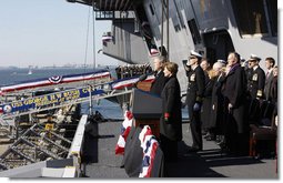 President George W. Bush stands with Mrs. Laura Bush during the playing of the national anthem at the commissioning ceremony of the USS George H. W. Bush (CVN 77) aircraft carrier Saturday, Jan 10, 2009 in Norfolk, Va., in honor of his father, former President George H. W. Bush, seen at right. White House photo by Eric Draper