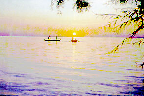 Photo of two boats on lake in sunset.