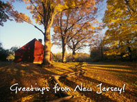 Photo of an old building next to a leaf covered road