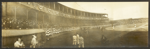 Baseball players on the field, with a view of the stands.