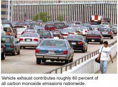 A picture of cars driving along a highway.