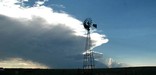 A lone windmill stands in evening light on the plains along the Santa Fe Trail