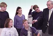 Students watch the tornado-in-a-bottle experiment