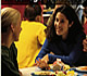 Two women students talking at cafeteria table