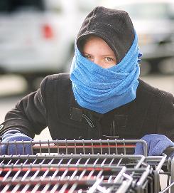 Heather Vose, 21, a Woods Supermarket employee in Sedalia, Mo., bundles up to ward off the frigid cold, on Wednesday.