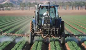 Tractor spraying crops