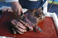 A chef cutting roast beef