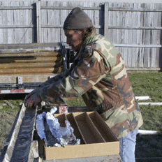 Geologist Bill Dey loads core inta a box for transport