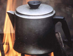 Photo of a coffee pot over camp fire