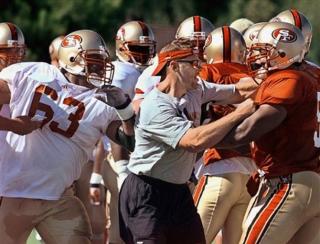 Tom Rathman breaks up a fight between Derrick Deese (63) and Ken Norton during his prior 49ers coaching days.