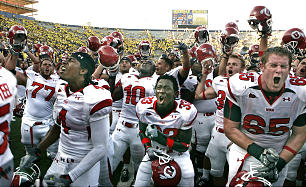 Utah's Sean Smith (4), Justin Taplin-Ross (33) and Dustin Hensel (65) celebrate as the University of Utah defeats then No. 24-ranked Michigan Wolverines, 25-23. (Tom Smart, Deseret News)