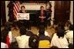 President George W. Bush and Laura Bush read "'Twas the Night Before Christmas," to a class of third-graders during the White House Story Hour in the Roosevelt Room Tuesday, Dec. 17.  White House photo by Tina Hager