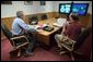 President George W. Bush conducts a National Security Council meeting via teleconference with General John Abizaid, in Crawford, Texas, Wednesday, April 7, 2004. The President received an update on military operations in Iraq. Also present is NSC Executive Secretary Greg Schulte.  White House photo by Eric Draper