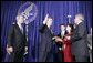 As President George W. Bush looks on, Mike Leavitt is sworn into office as Secretary of Health and Human Services by Chief of Staff Andrew Card. With Mr. Leavitt are his wife, Jackie, and son, Westin. The ceremony took place in the Great Hall at the U.S. Department of Health and Human Services.  White House photo by Paul Morse