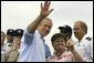 President George W. Bush waves as student Dorothy James points out other students at the Paul Hall Center for Maritime Training and Education in Piney Point, Md. Monday, September 4, 2006.  White House photo by Kimberlee Hewitt