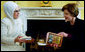 Laura Bush accepts books of poetry by Turkish poet Rumi presented by Emine Erdogan, wife of the Prime Minister of Turkey, during a coffee at the White House Thursday, Jan. 29, 2004.  White House photo by Susan Sterner