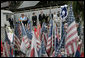 During their visit to Ground Zero, President George W. Bush and Laura Bush look at a memorial created from some of the objects visitors have brought to the site in New York City Sunday, September 10, 2006.  White House photo by Eric Draper