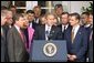 Standing with members of Congress, President George W. Bush discusses America's position on Iraq in the Rose Garden Thursday, Sept. 26. "We are moving toward a strong resolution. And all of us, and many others in Congress, are united in our determination to confront an urgent threat to America," explained the President. "And by passing this resolution we'll send a clear message to the world and to the Iraqi regime: the demands of the U.N. Security Council must be followed."  